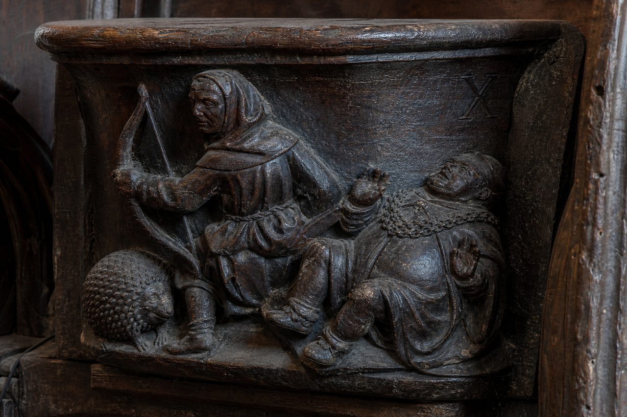 misericord carving with archer and hedgehog
